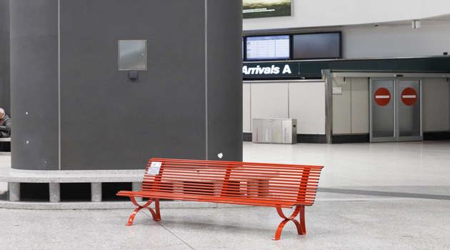 Two red benches at Milan Malpensa airport