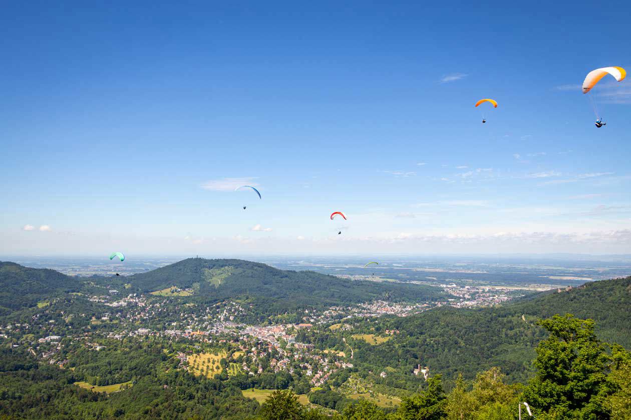 View of Baden-Baden from Merkur Mountain with paragliders. Copyright © Baden-Baden Kur & Tourismus GmbH