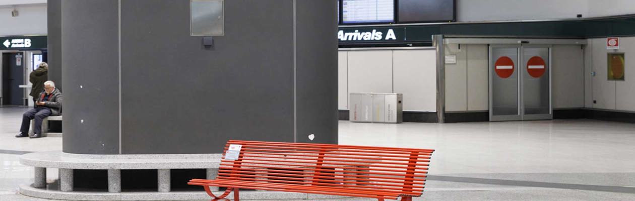 Two red benches at Milan Malpensa airport